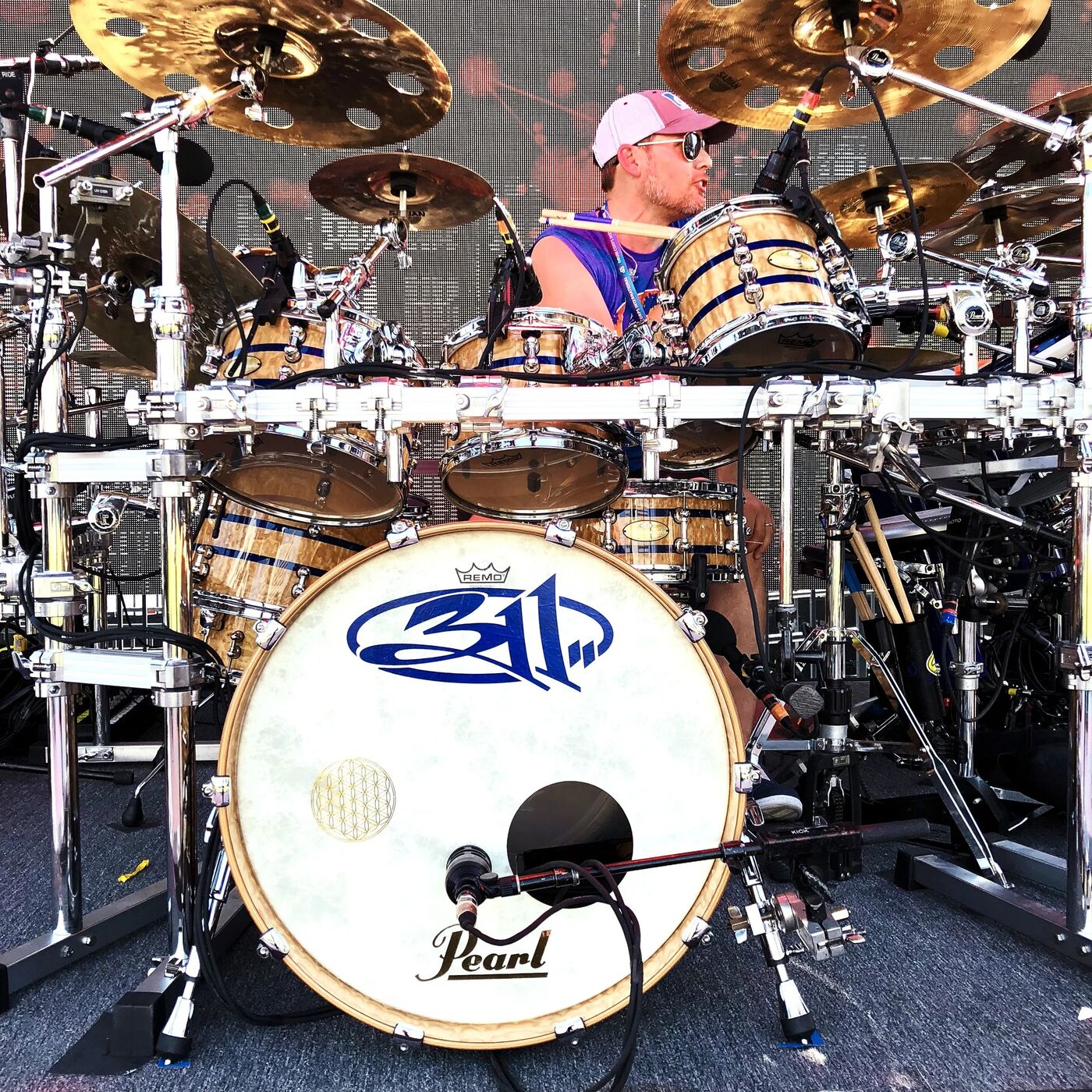 311's drummer behind a Pearl drum kit with the 311 logo on the bass drum