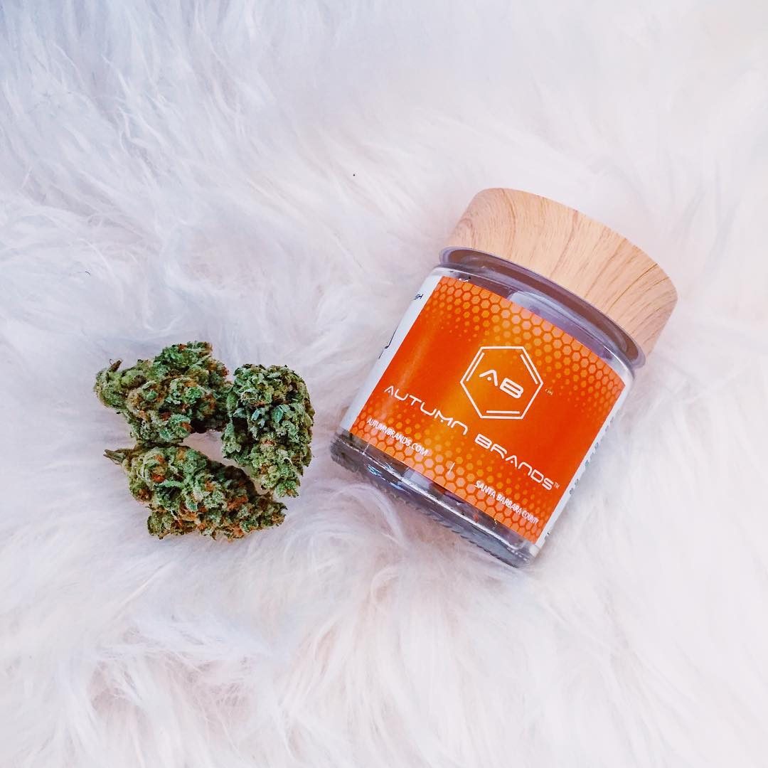Autumn Brands jar and flower on white fur