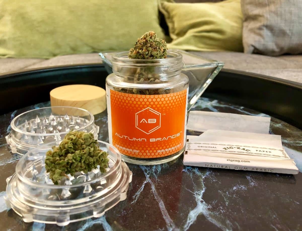 Autumn Brands jar with grinder and rolling papers