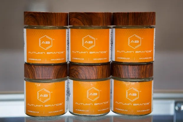 Stacked Autumn Brands flower jars with wood-grain lids