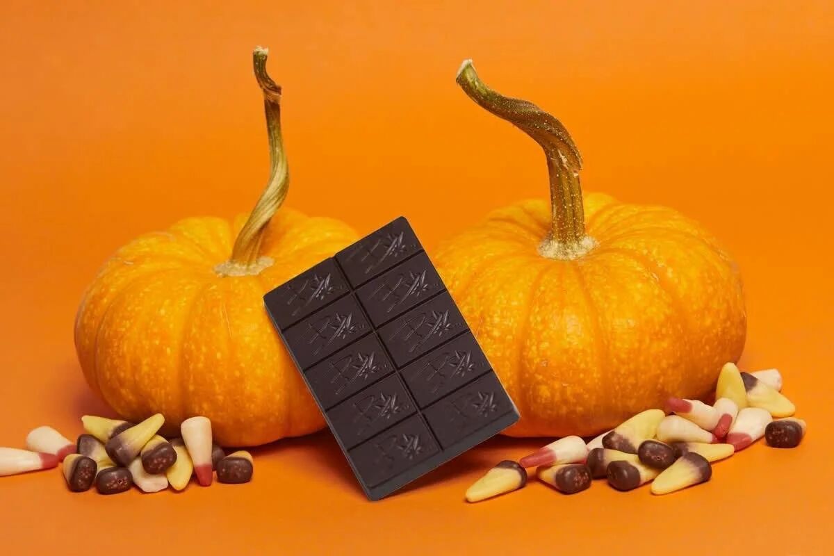 Bhang chocolate bar with pumpkins and candy corn on orange