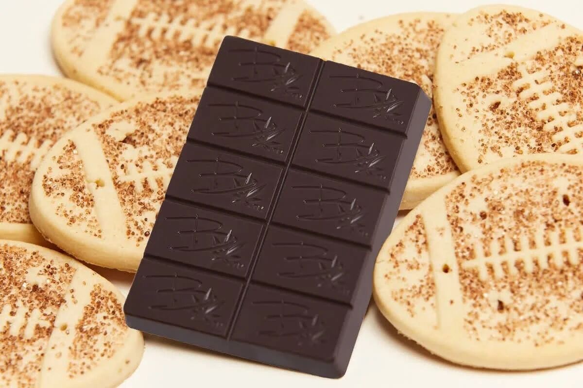Bhang dark chocolate bar on a pile of shortbread cookies