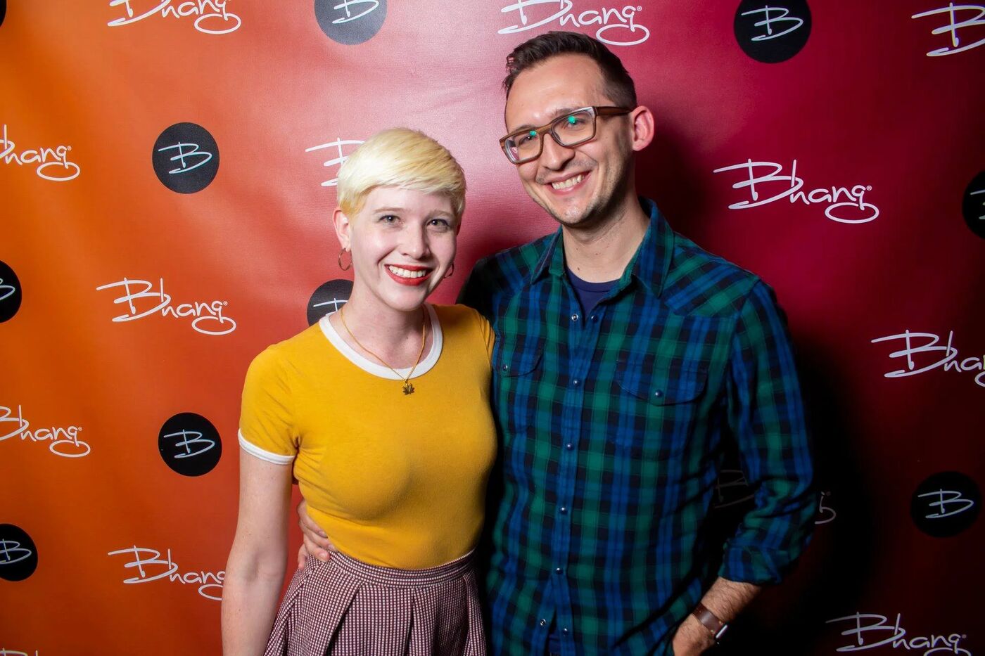 Two guests posing in front of the Bhang step-and-repeat