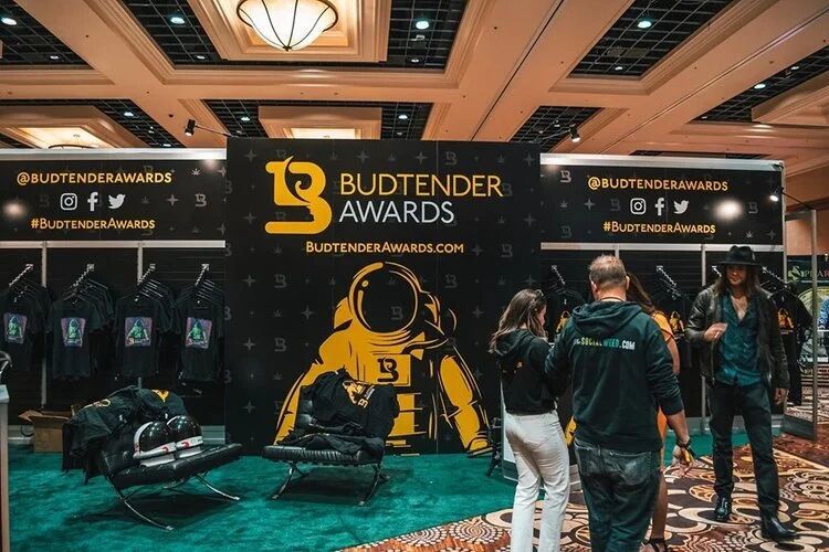 Budtender Awards booth with an astronaut mascot and merch at the expo