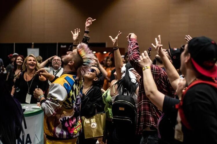 Crowd cheering with hands raised at a Budtender Awards event