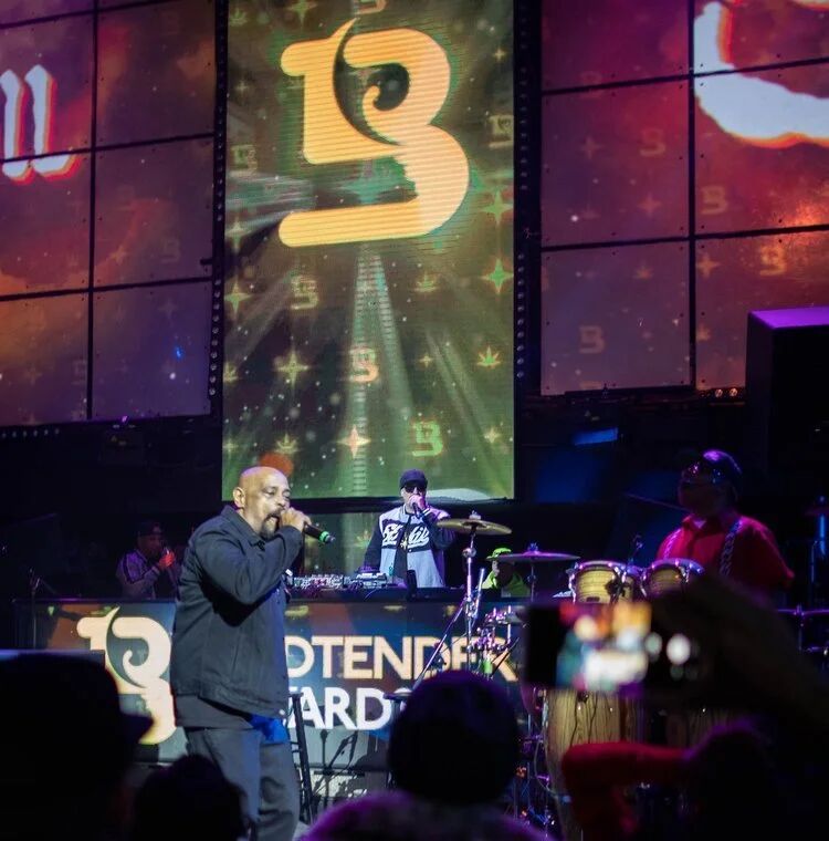 Performer on stage under the Budtender Awards logo screen