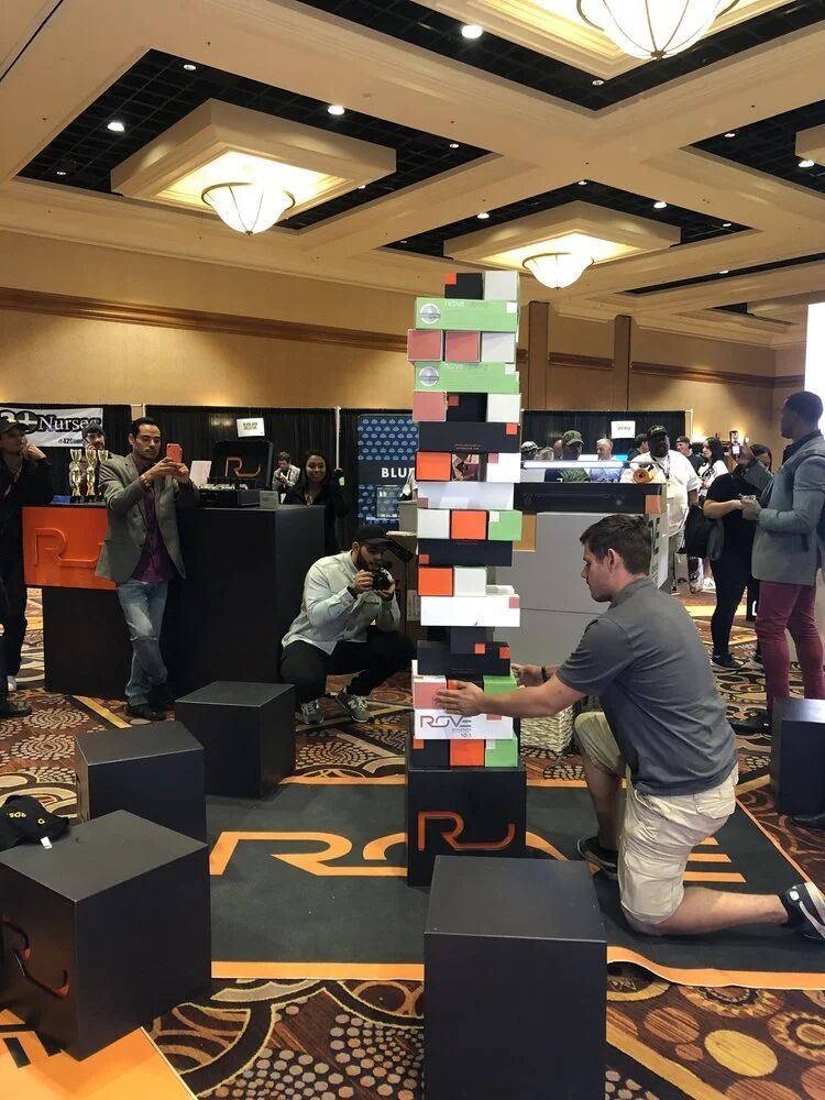 Guests playing giant block-stacking game at the expo