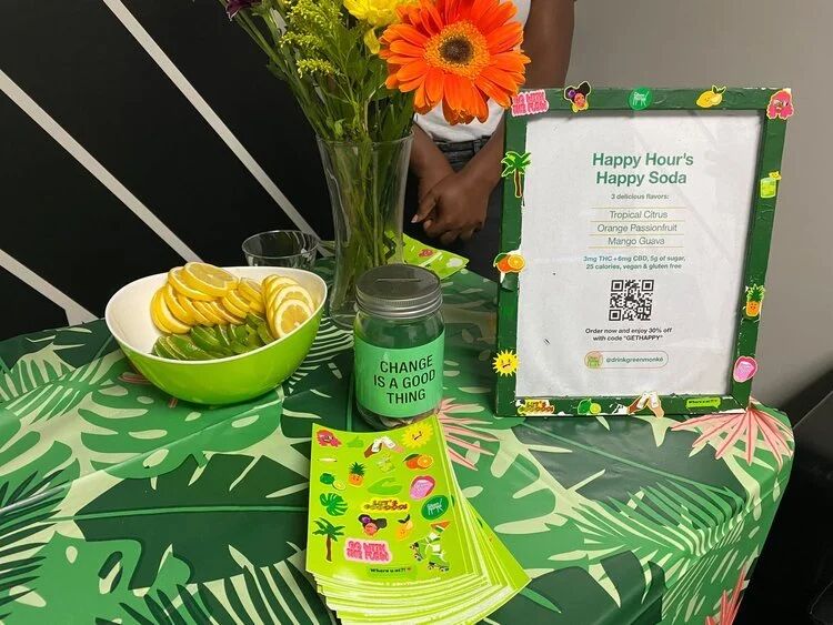 Happy Hour's Happy Soda display with fruit and flowers at a Budtender Sessions table
