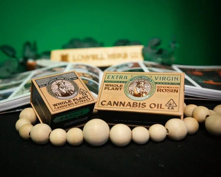 Lowell Herb Co. cannabis oil and rosin boxes on a display table