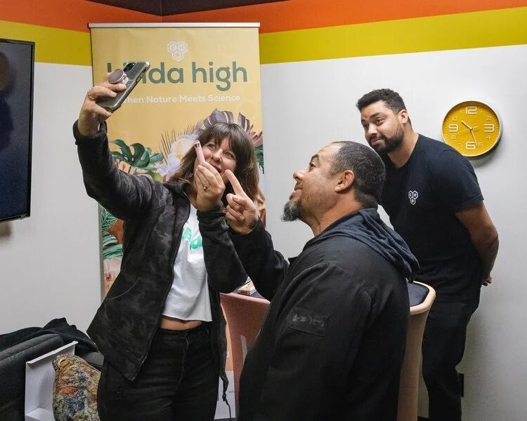 Guests taking a selfie at a Kinda High booth