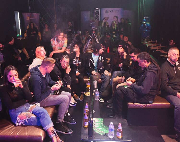 Crowded Budtender Sessions lounge with guests seated on couches