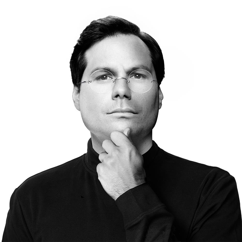 Michael Ian Black in a black turtleneck, Steve Jobs portrait parody