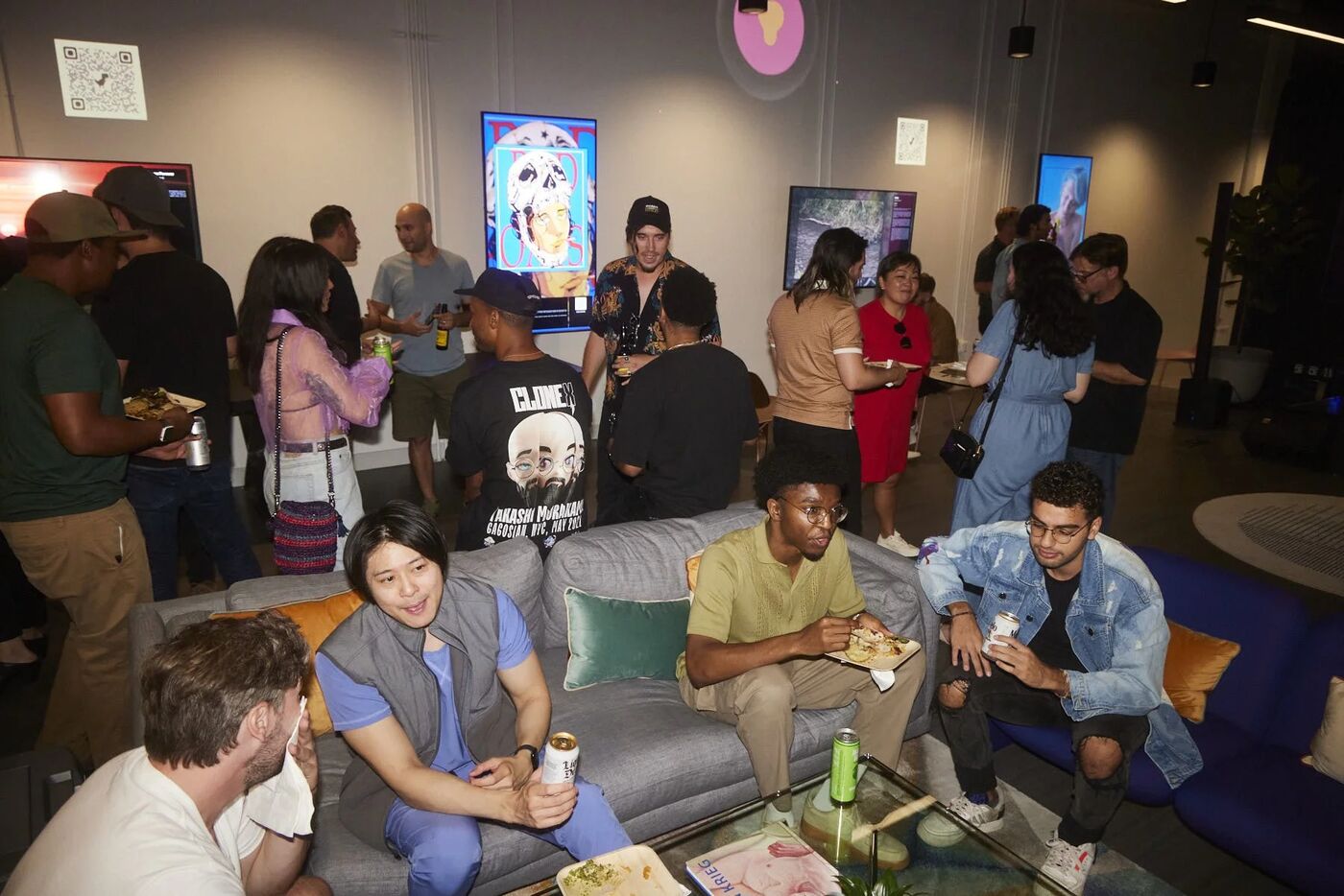 Guests relaxing on couches in the gallery lounge