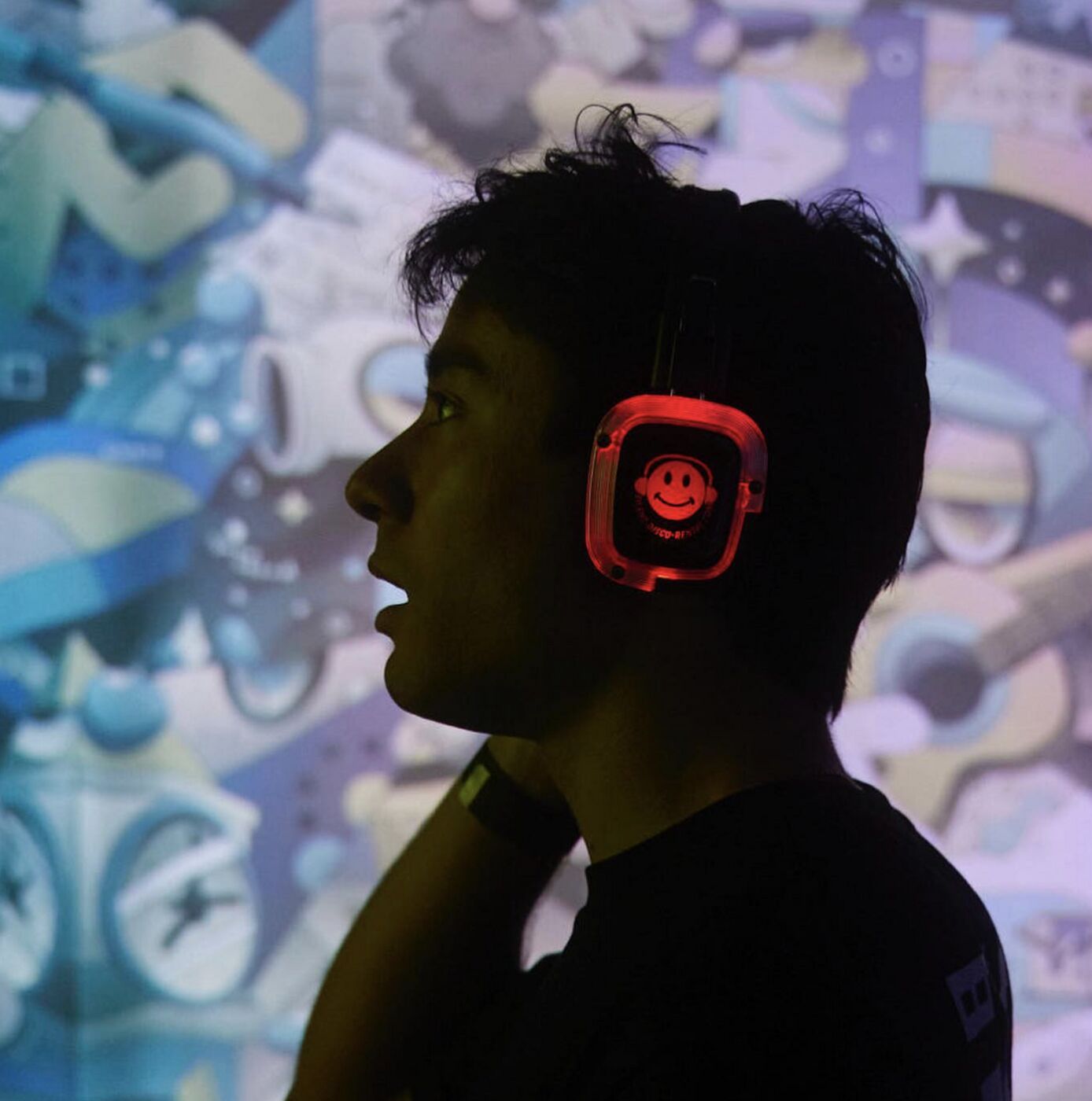 Profile of a guest in glowing smiley-face headphones