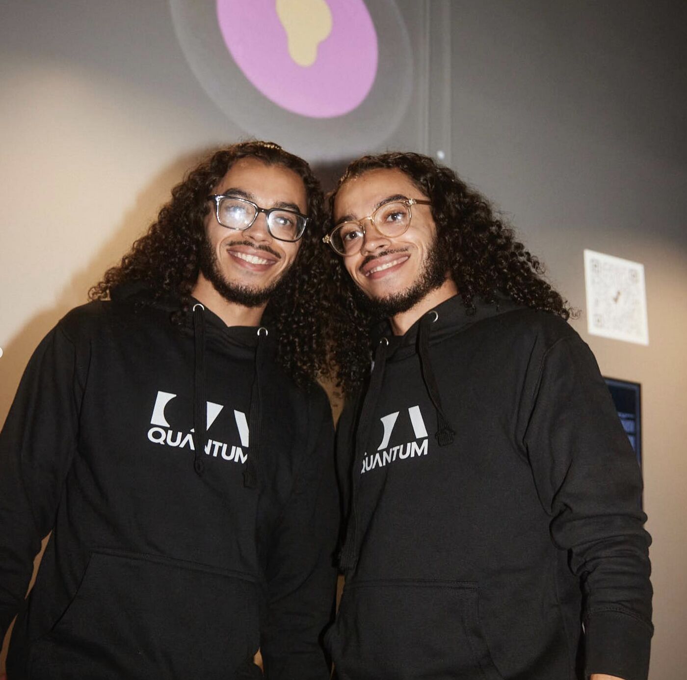 Two Quantum team members in matching hoodies
