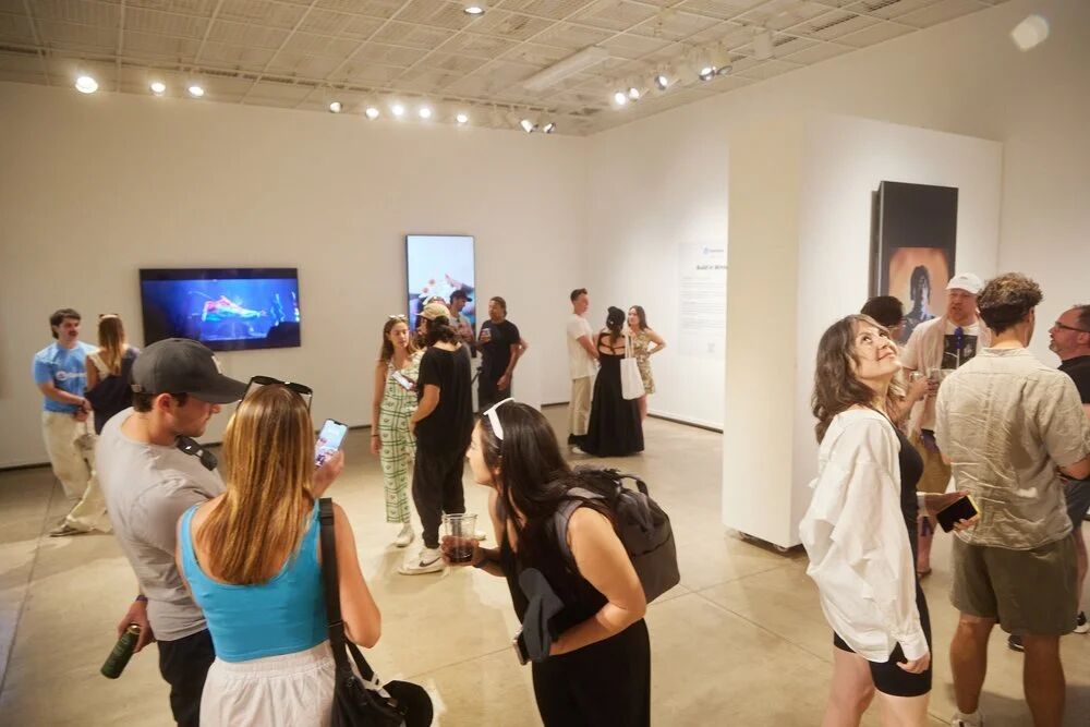 Guests viewing digital art screens in the OpenSea gallery at FWB Fest 2023