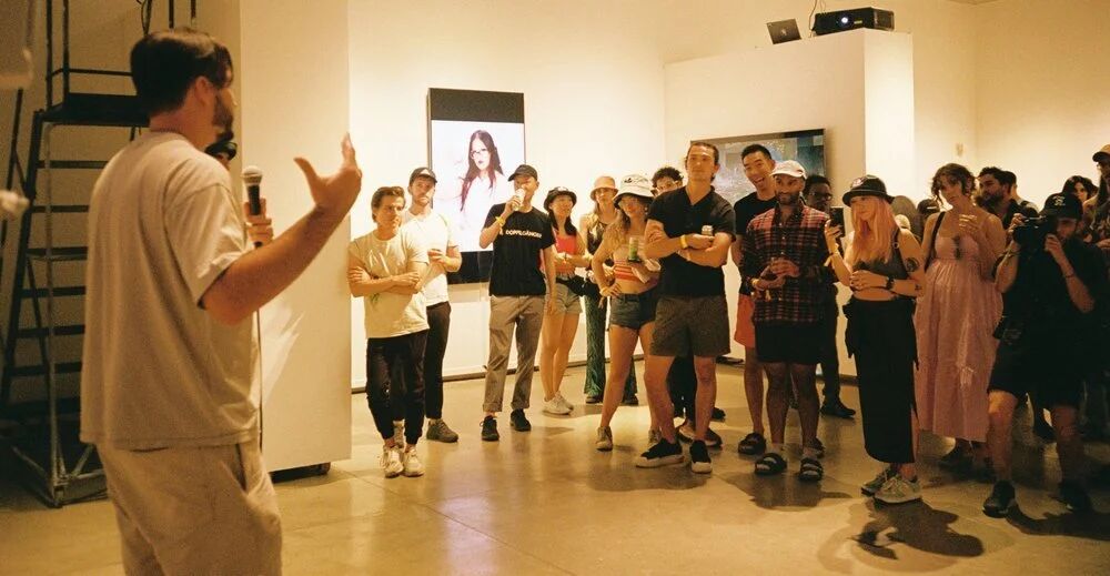 Artist talk for a group of guests inside the OpenSea gallery