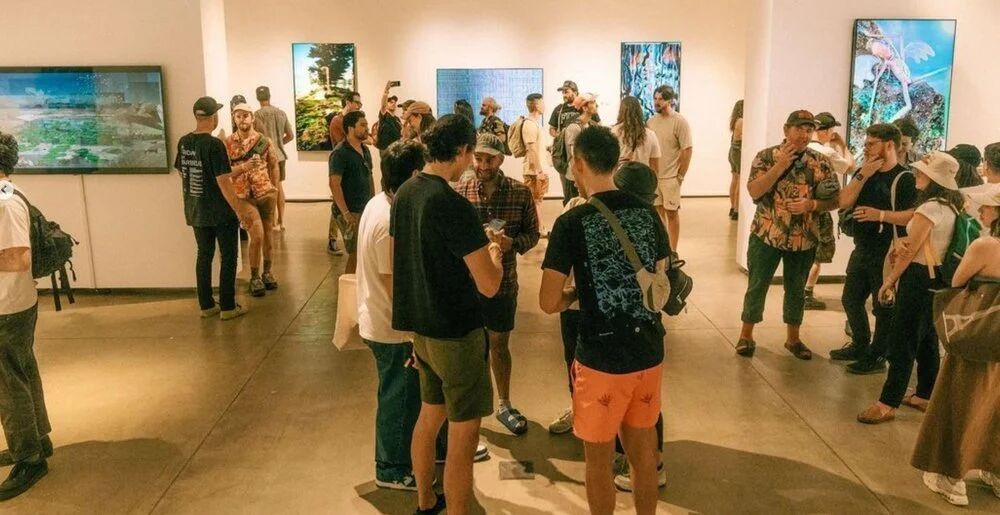 Wide view of a crowd in the OpenSea gallery at FWB Fest