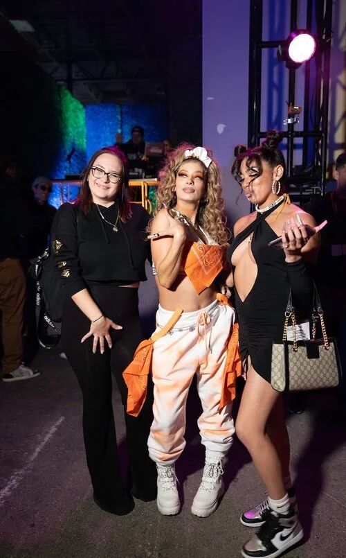 Guests posing at a G4 Live nighttime party