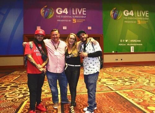 Four attendees in front of the G4 Live backdrop