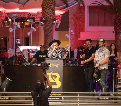 DJ booth with the Budtender Awards logo at an outdoor G4 Live party