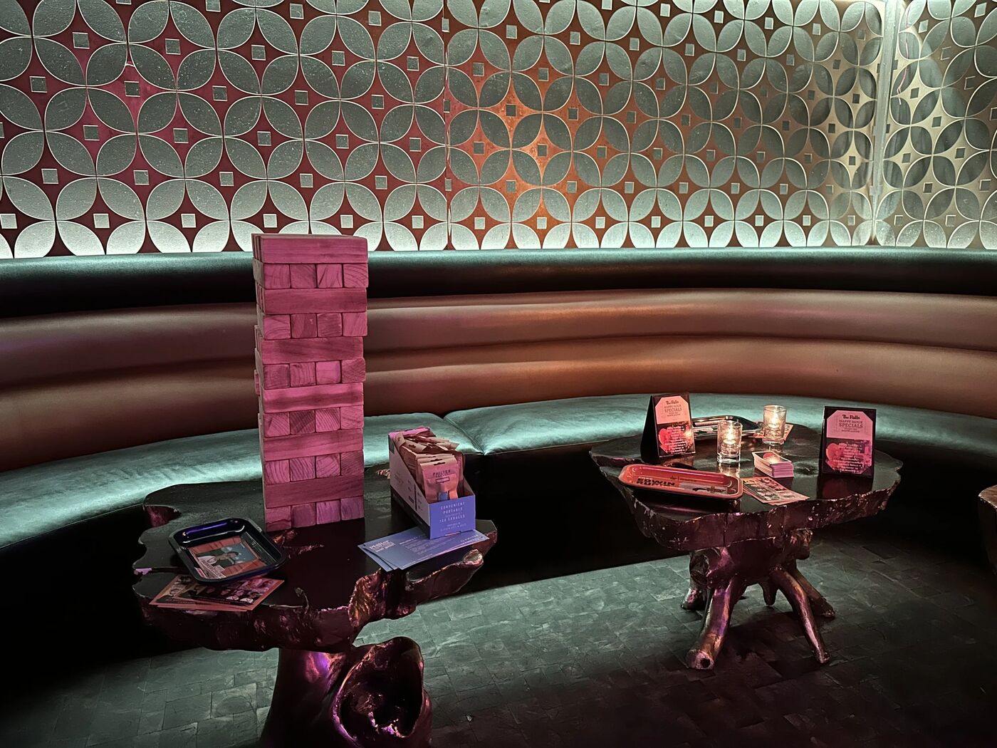 Lounge booth with a Jenga tower and tables set for the event