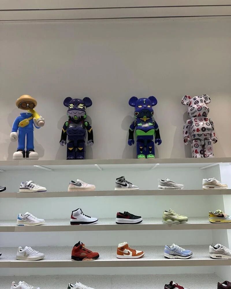 Invisible Friends toy displayed at Kith beside designer figures and sneakers