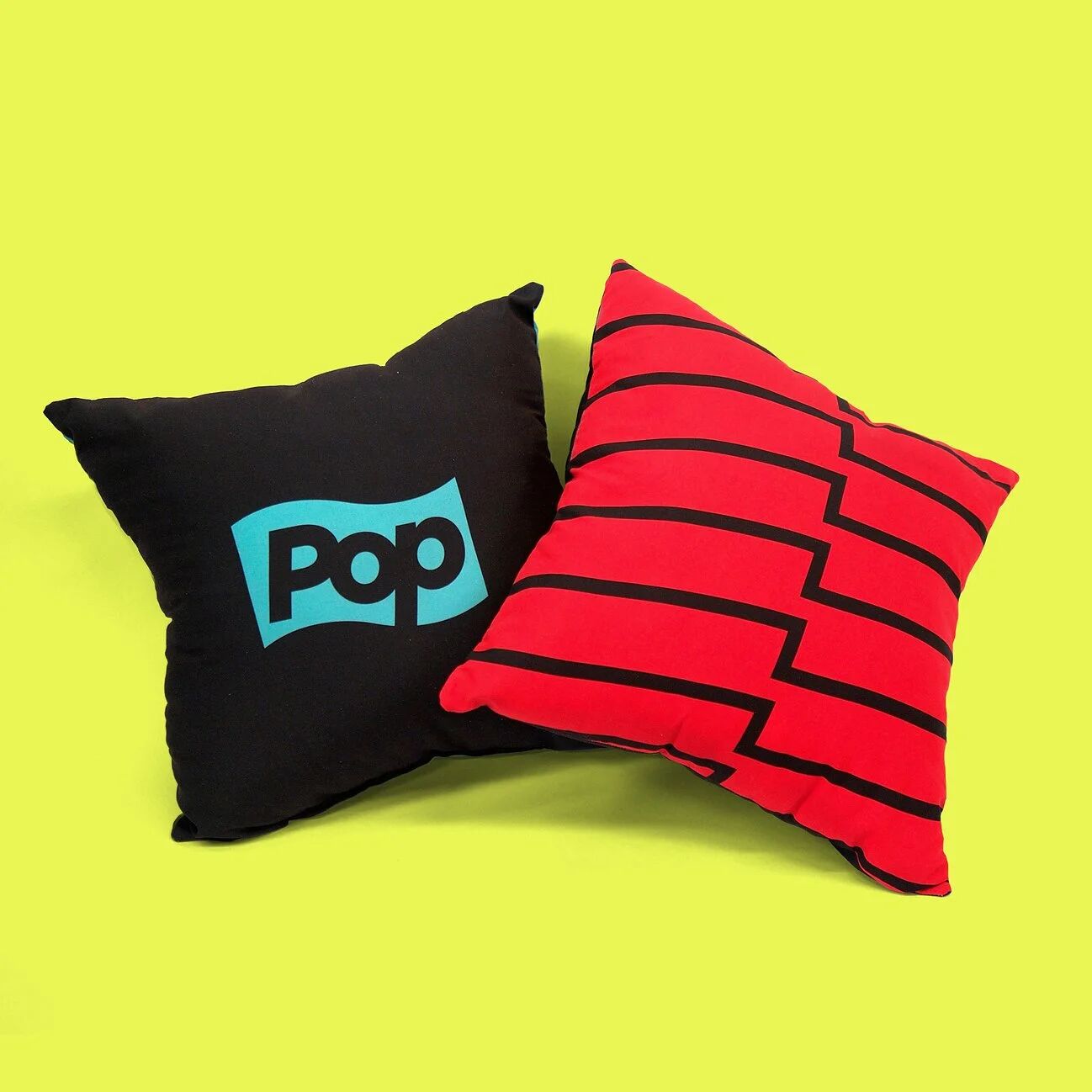 Pop TV logo pillow and striped pillow on yellow