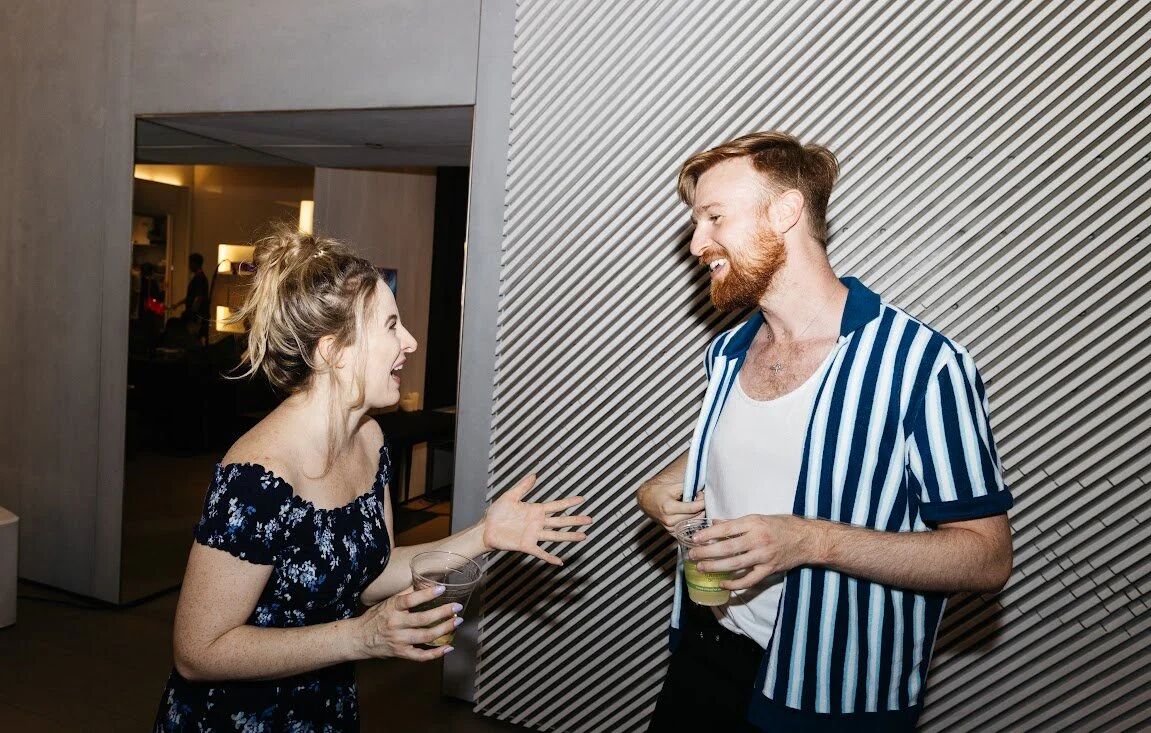 Two guests talking at the Pride Perspectives gallery event