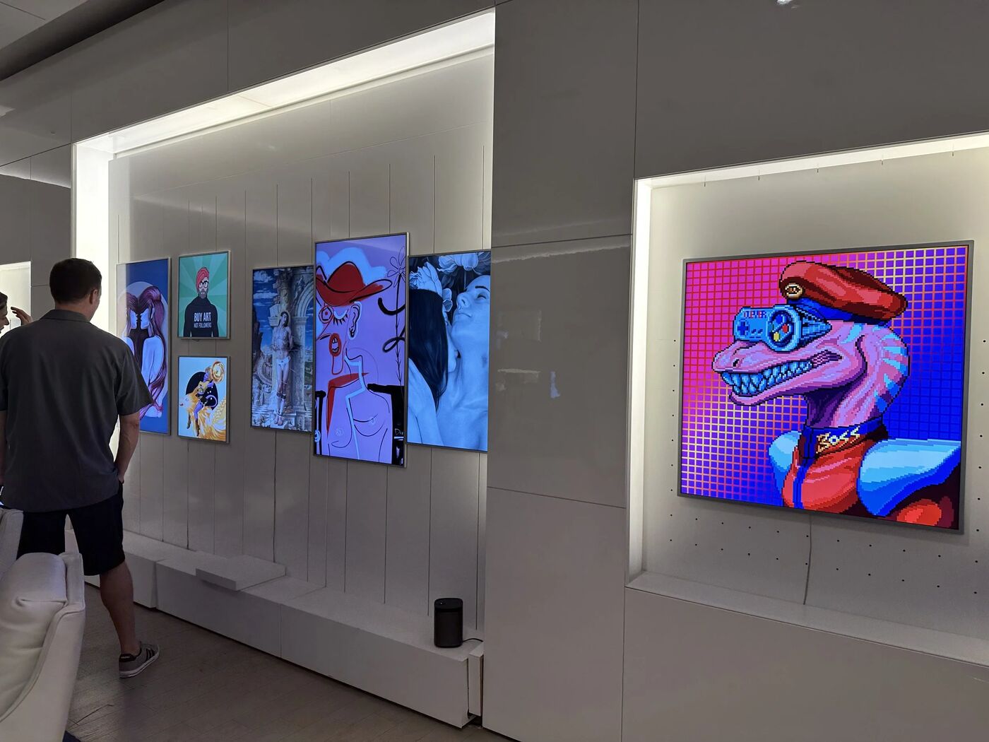 Visitors viewing illuminated digital art in the Pride Perspectives gallery