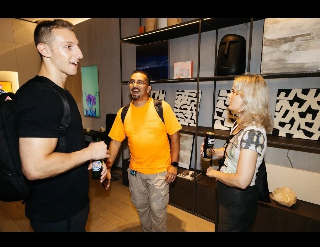 Three guests chatting at OpenSea's Pride Perspectives gallery