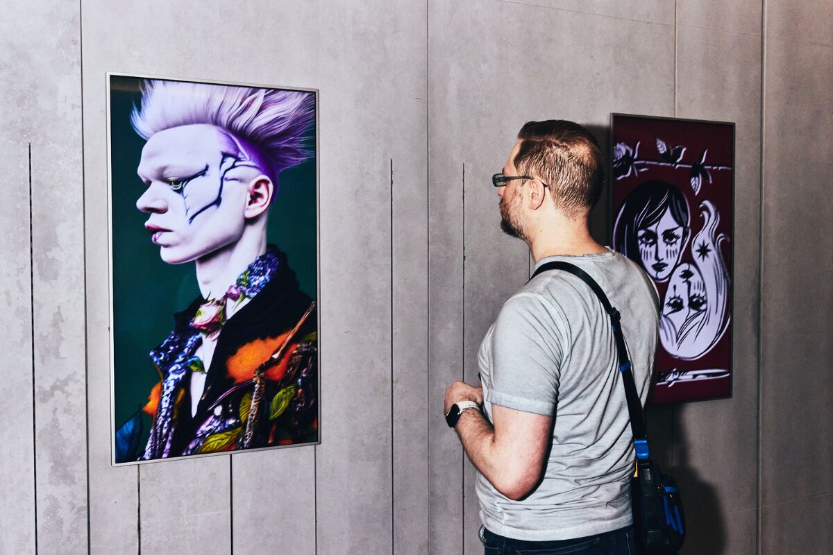 Visitor viewing a portrait artwork at Pride Perspectives