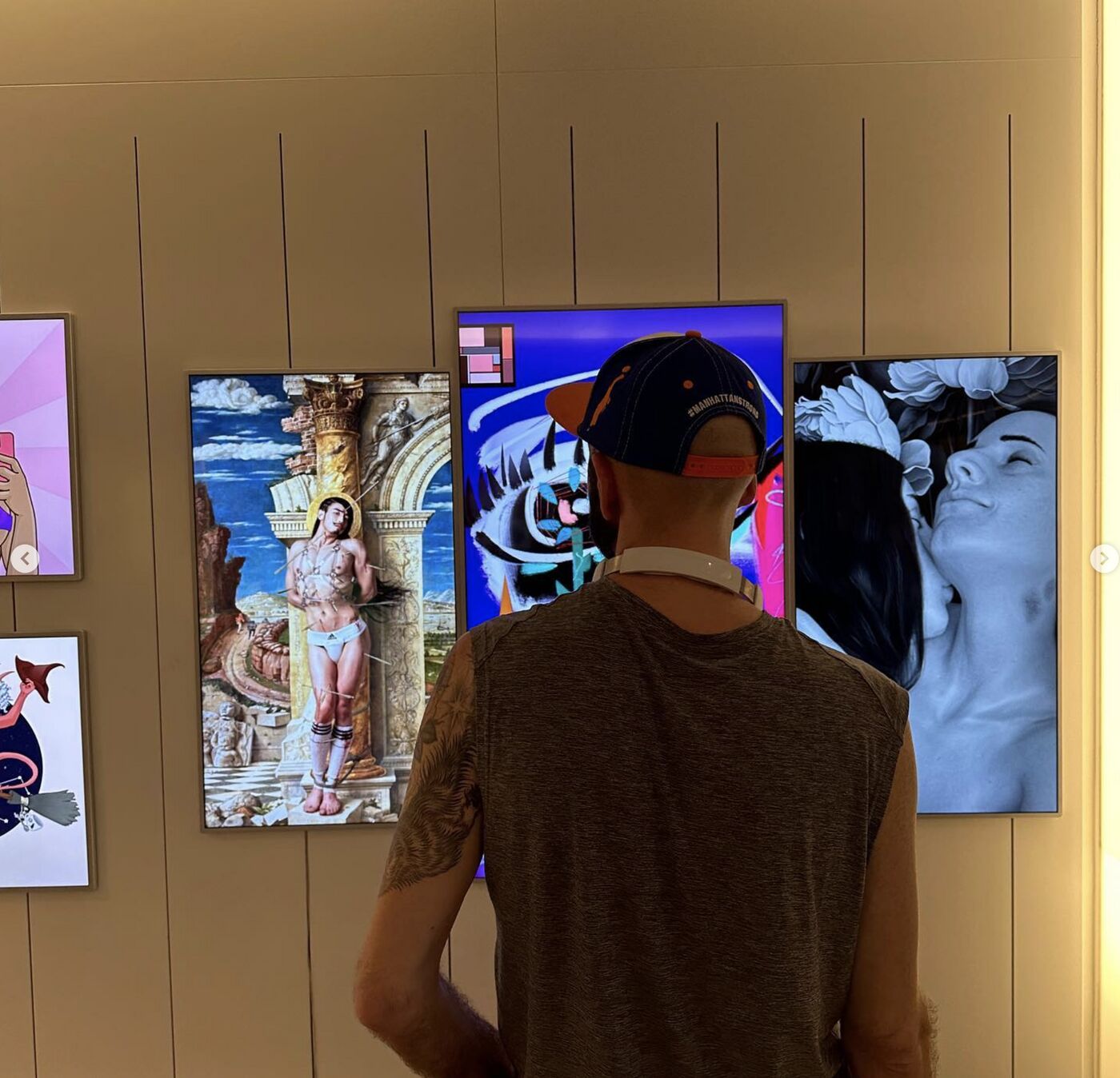 Visitor viewing digital artworks at Pride Perspectives