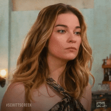Animated Schitt's Creek GIF: a side-eye glance