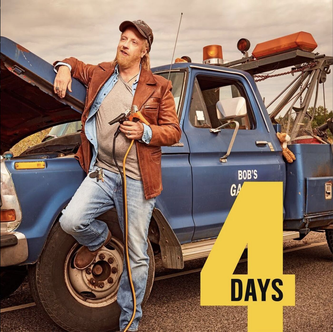 Schitt's Creek countdown: 4 days. A cast member leaning on Bob's Garage tow truck