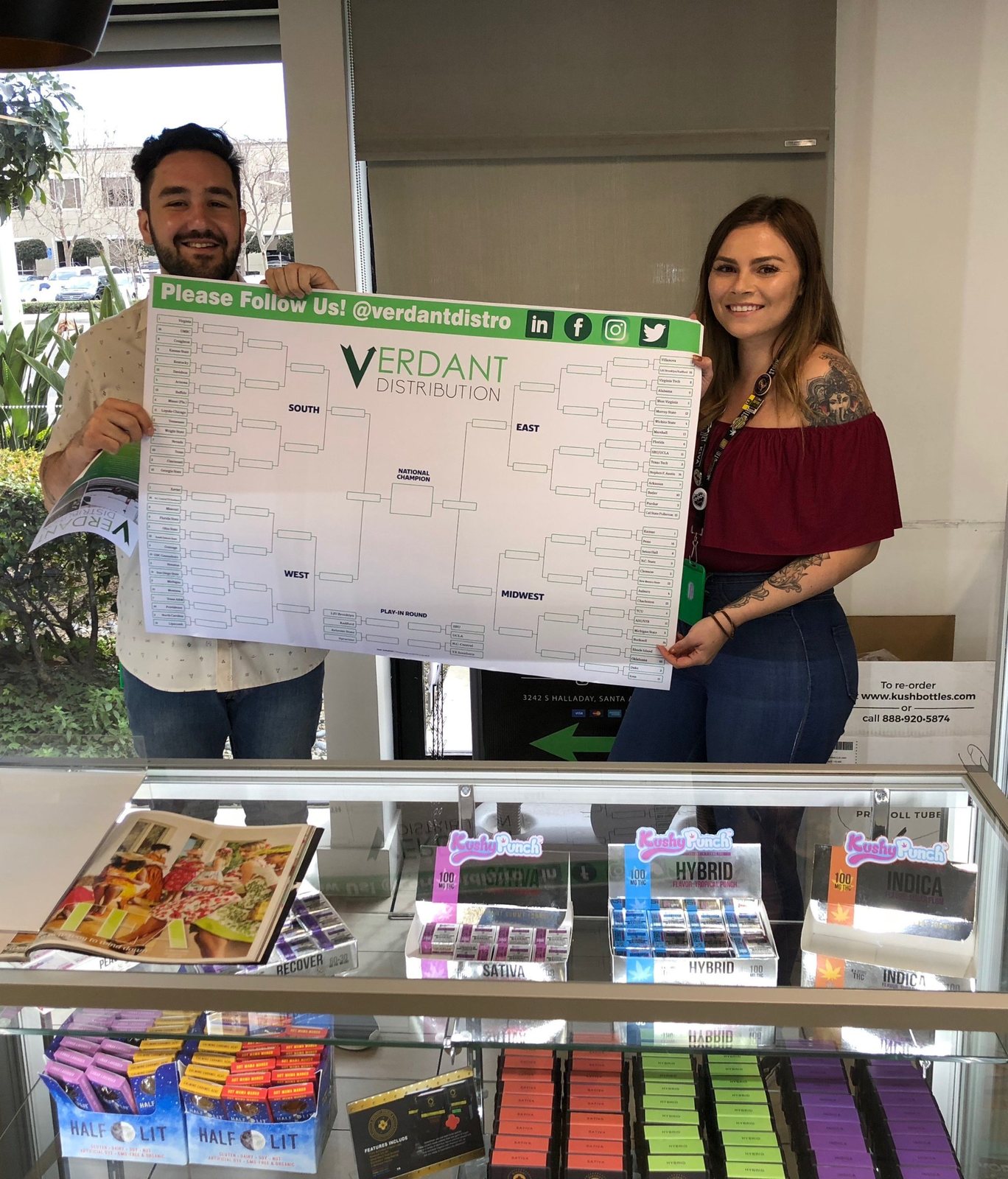 Dispensary team holding the Verdant Distribution bracket poster