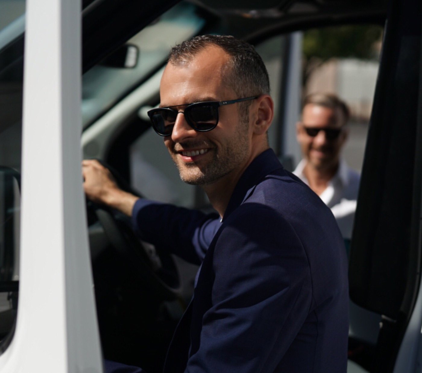 Verdant team member smiling from the driver's seat of a delivery van