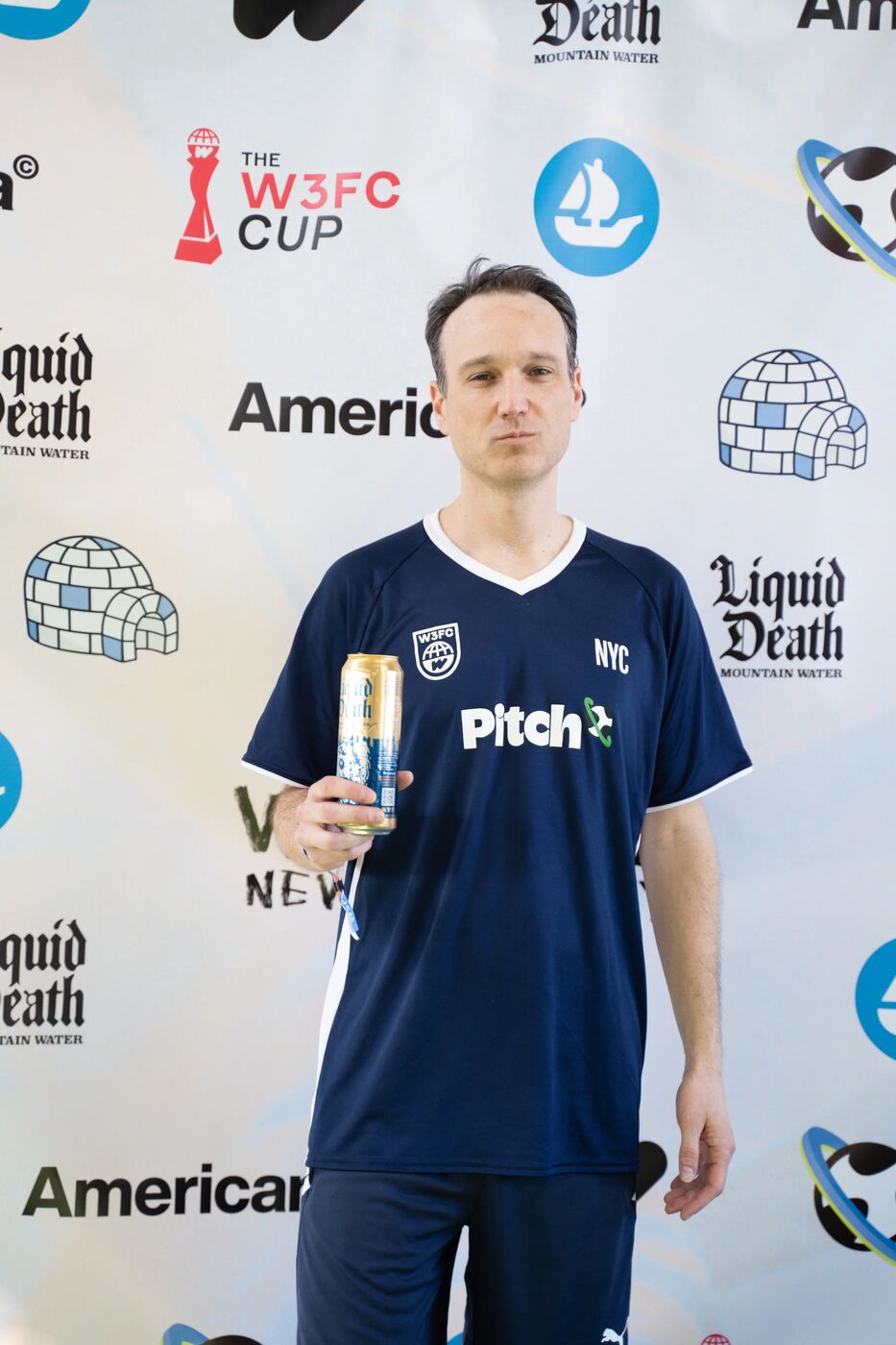 Player in a navy NYC jersey at the W3FC Cup step-and-repeat