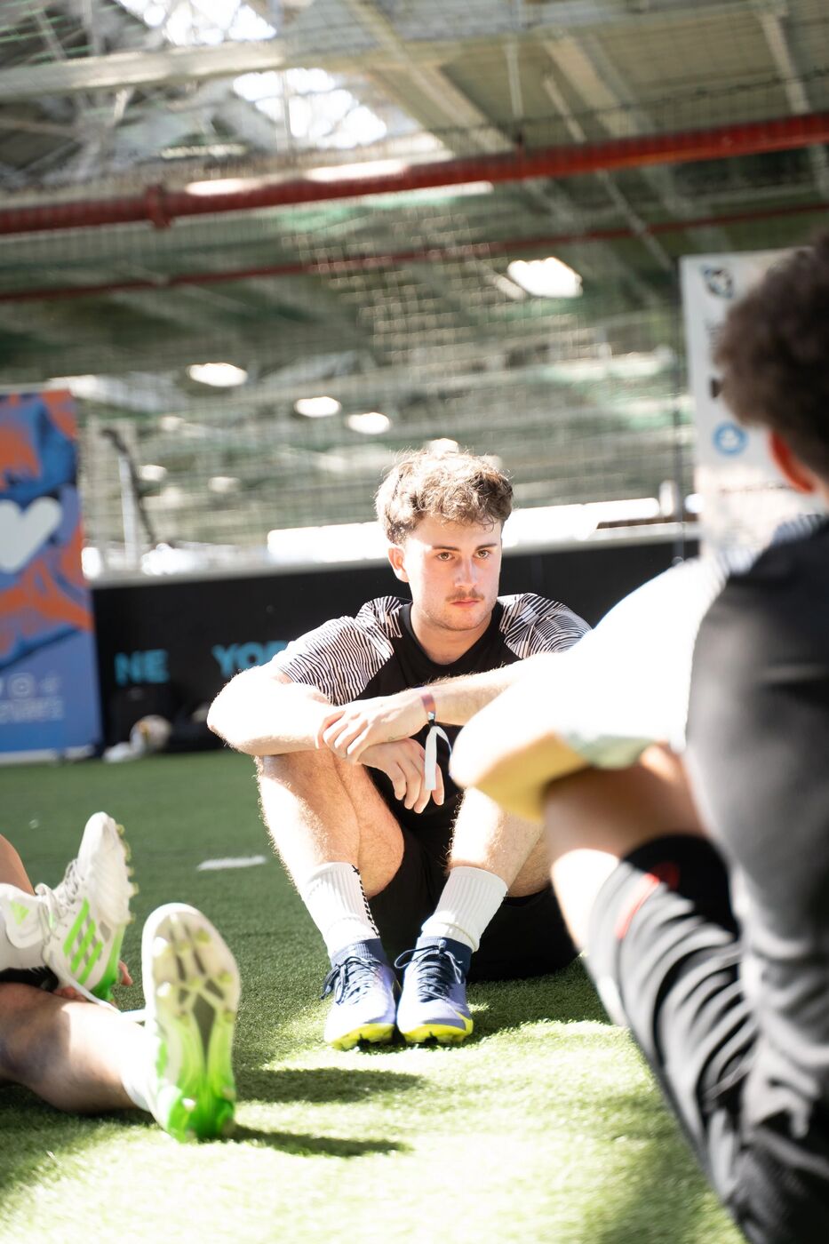 Players resting on the turf between matches at W3FC