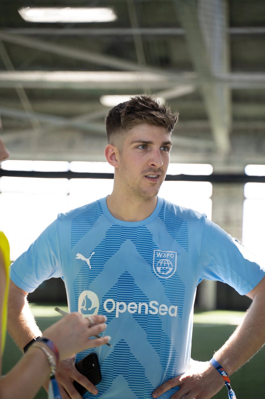Player in an OpenSea-sponsored light blue jersey at W3FC