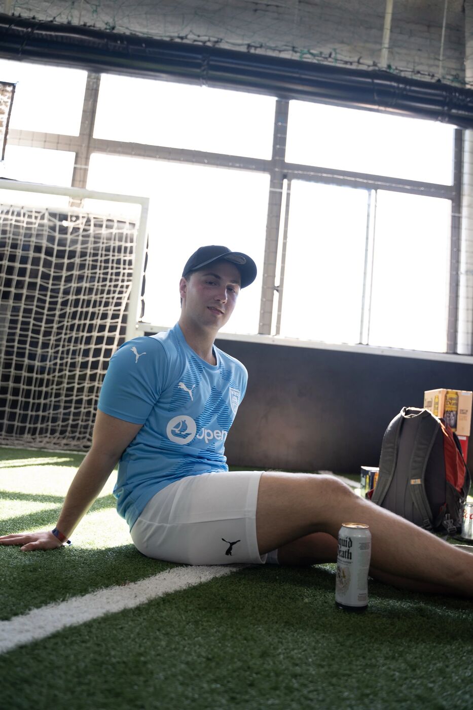 Player in an OpenSea jersey resting on the turf
