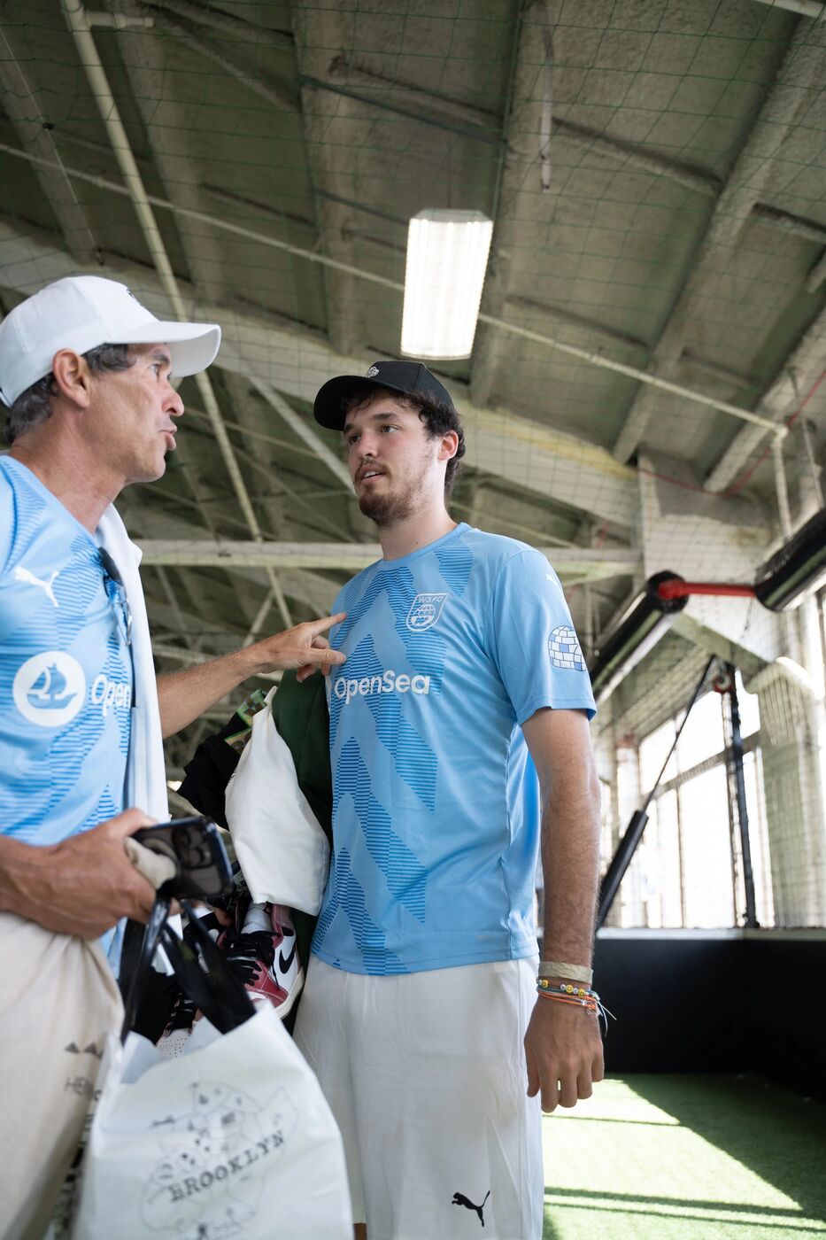 Two W3FC participants talking on the sideline