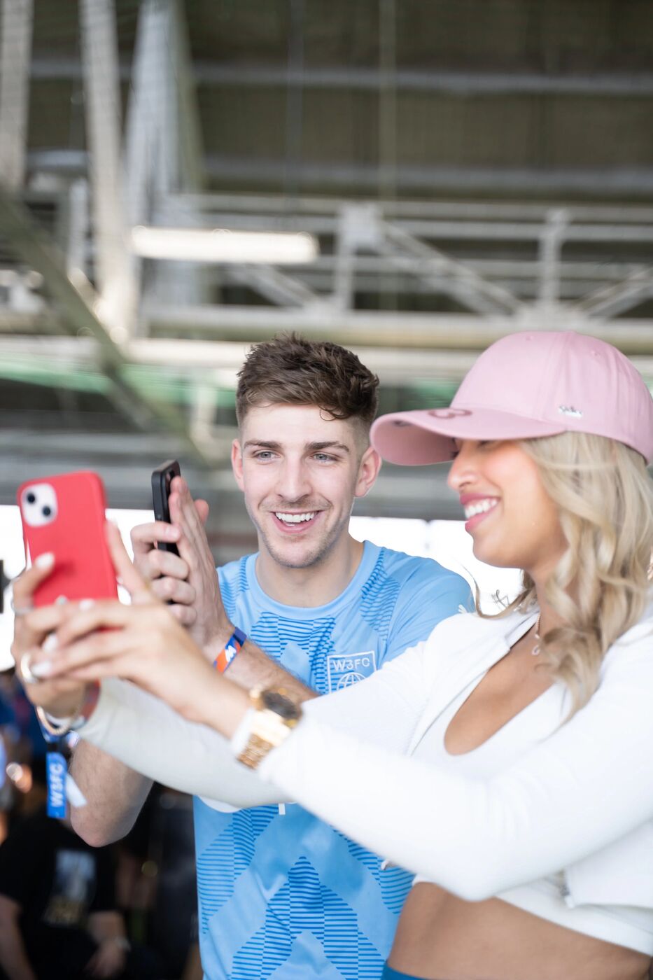 Player in an OpenSea jersey taking a selfie with a fan