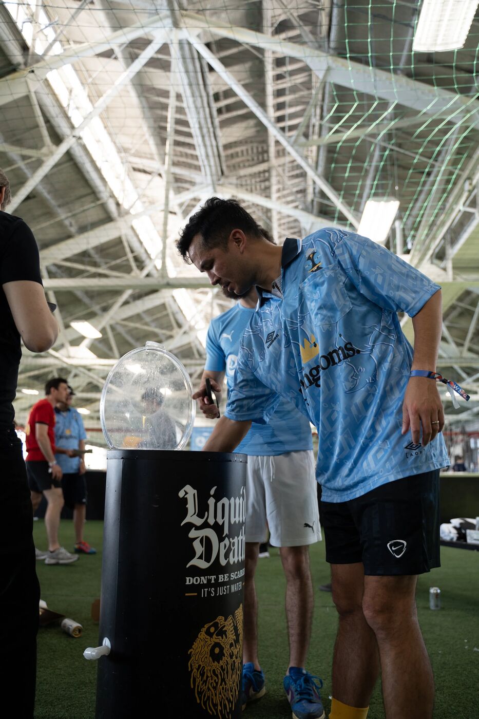 Players grabbing drinks from a Liquid Death cooler at W3FC