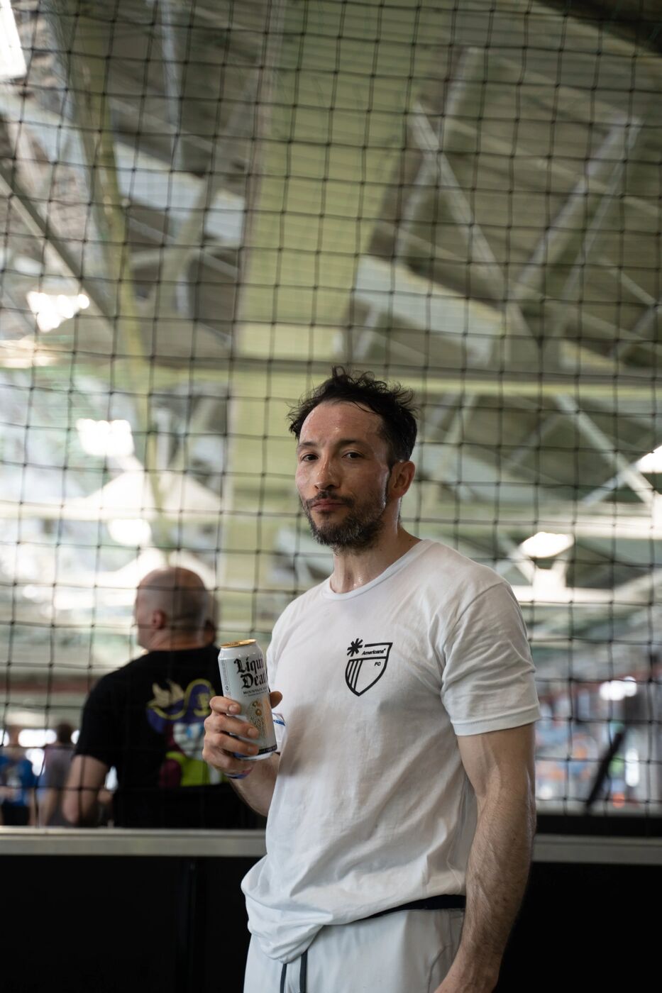 Player in a white kit holding a drink