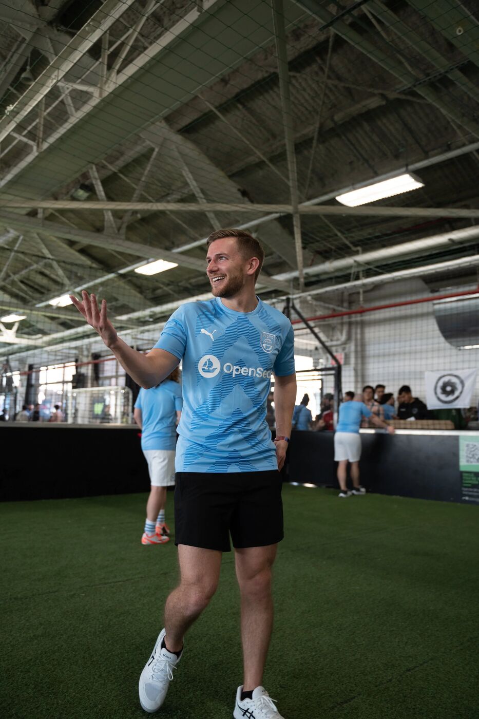Player in an OpenSea jersey gesturing on the pitch
