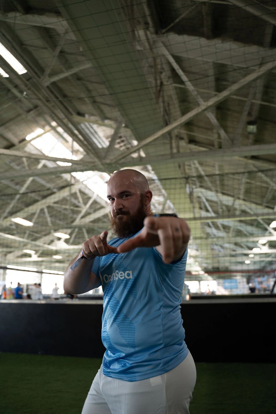 Player in an OpenSea jersey pointing at the camera